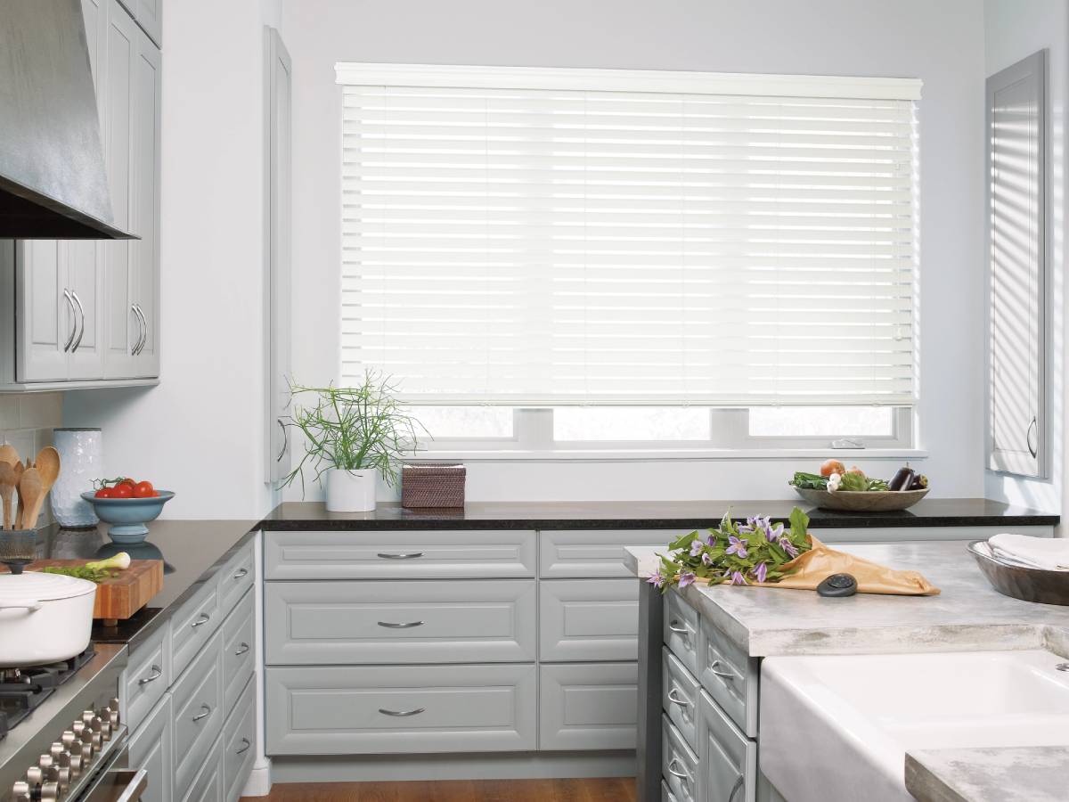 Homepage 8 Hunter Douglas Everwood® Faux Wood Blinds covering a kitchen window.
